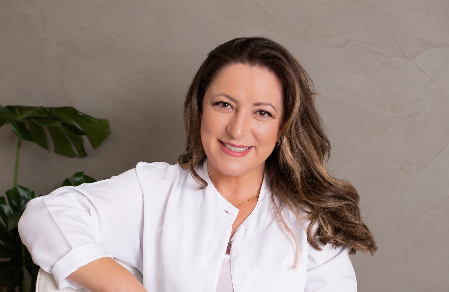 Janaína Tomchak, fisioterapeuta, sorrindo no consultório
